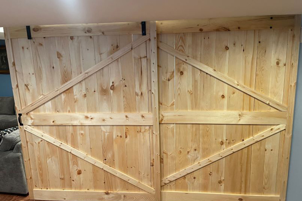 A rustic barn door featuring two prominent wooden slats, showcasing natural textures and earthy tones.